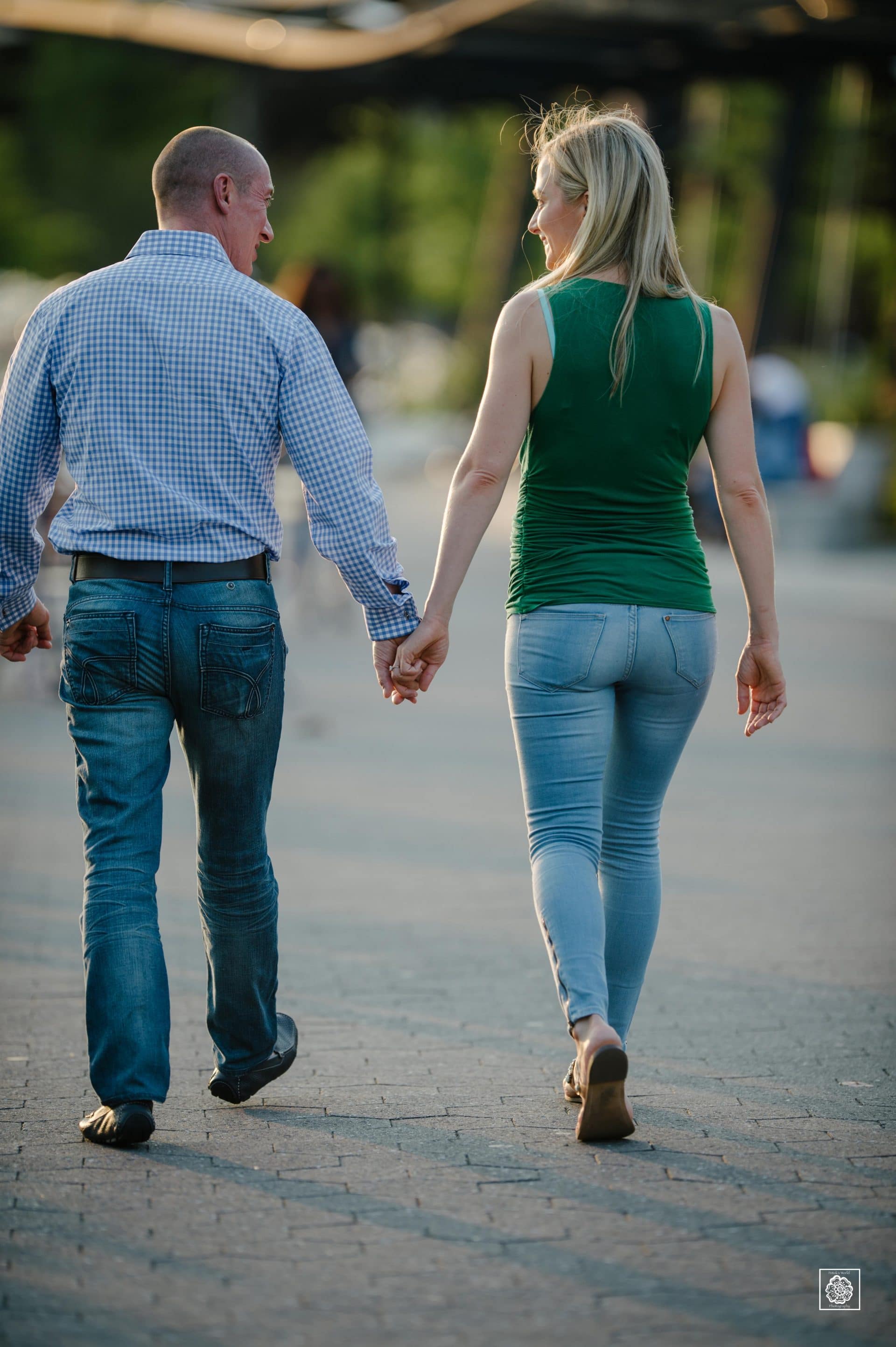 Couple walking hand in hand during engagement photo session at the Georgetown waterfront by DC wedding photographers of Potok's World Photography