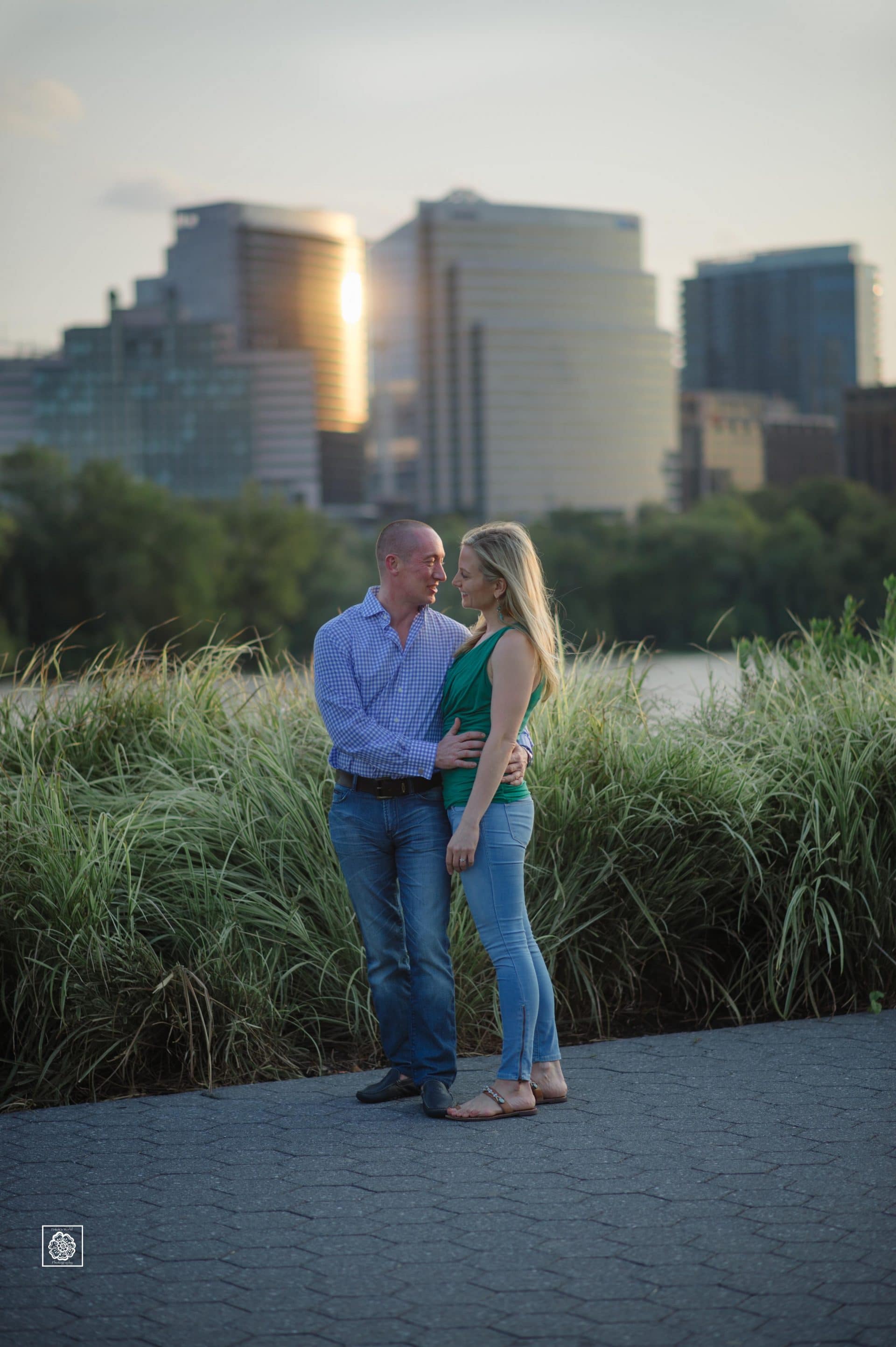 Engagement photo at the Georgetown waterfront with Rosslyn Skyline in the background by DC wedding photographers of Potok's World Photography