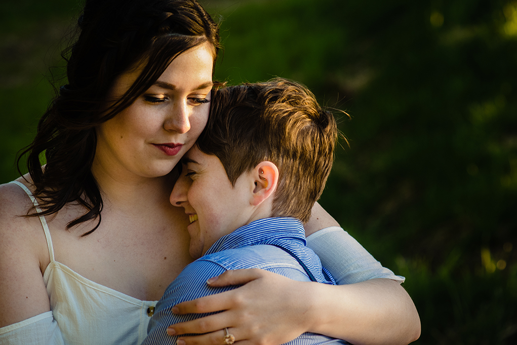  Two brides-to-be hugging in the setting sun during Great Falls engagement photos by Potok's World Photography, engagement photographers in Maryland.