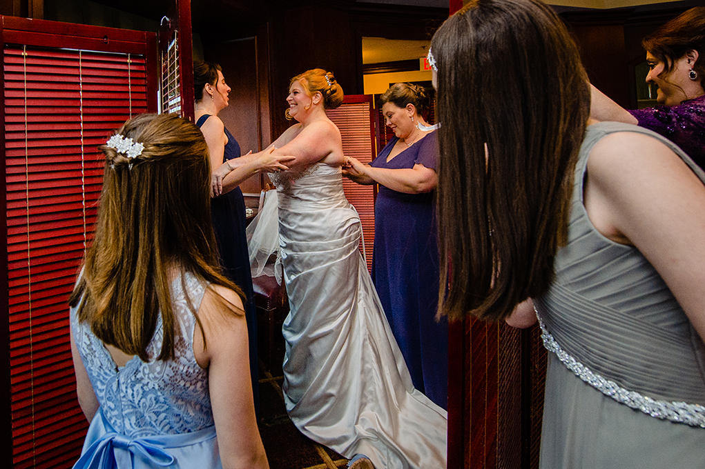 Bride getting into her wedding gown at the Mount Vernon Country Club wedding in Alexandria Virginia photographed by Potok's World Photography based in Washington DC