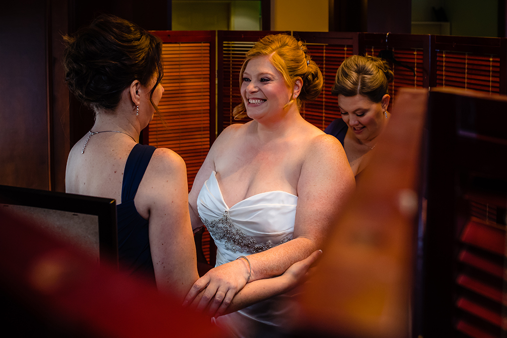 Bride getting into her wedding gown at the Mount Vernon Country Club wedding in Alexandria Virginia photographed by Potok's World Photography based in Washington DC