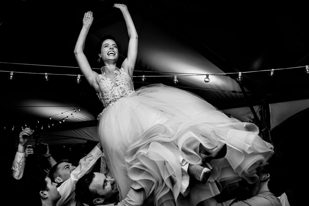 Bride thrown up in the air on dance floor at a wedding reception at 101 Constitution which is one of the best wedding venues in DC by Potok's World Photography