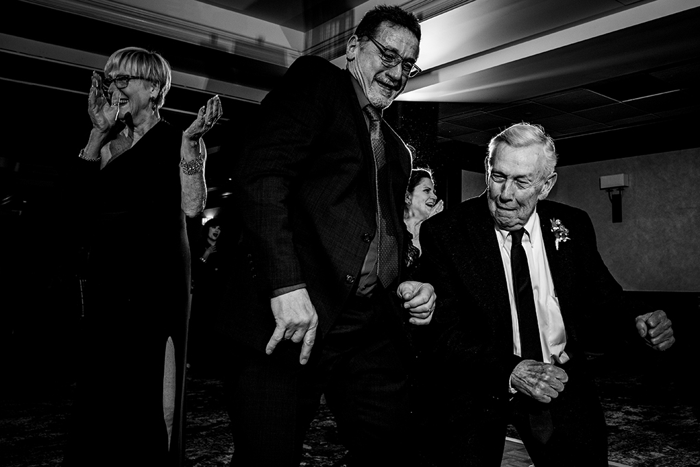 Father of the bride shaking a leg at City Club of Washington reception by DC wedding photographers Anji and Pete Martin of Potok's World Photography 