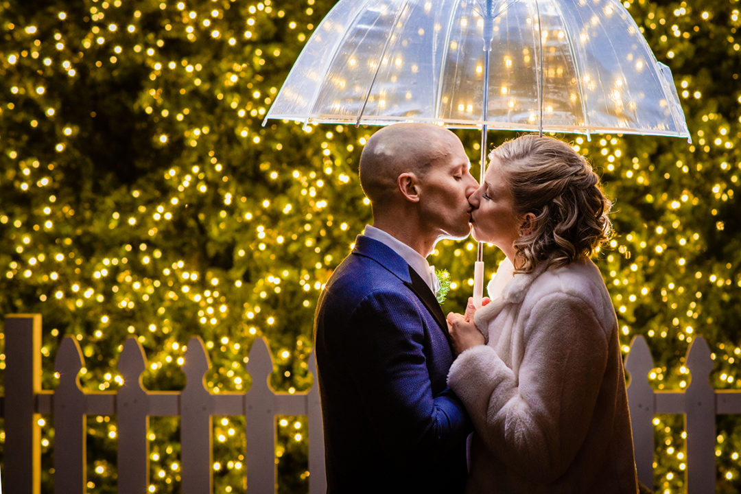 Bride and groom portrait in front of a Christmas tree in old town Alexandria before Carlyle Club reception by DC wedding photographers Potok's World Photography