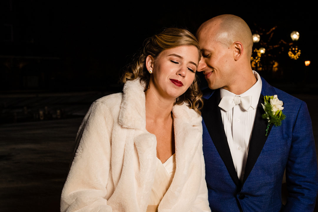 Bride and groom portrait in front of a Christmas tree in old town Alexandria before Carlyle Club reception by DC wedding photographers Potok's World Photography