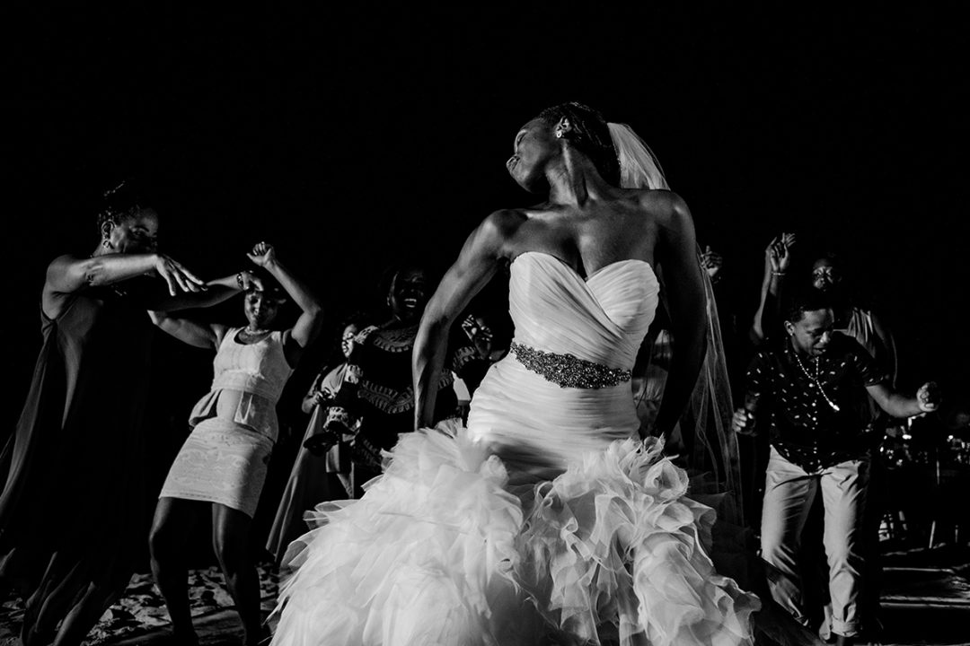 Wedding day timeline: Bride dancing during destination wedding Punta Cana beach wedding by DC wedding photographer Potok's World Photography