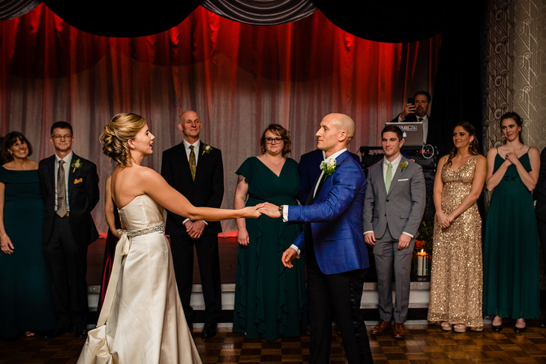 Bride and groom's first dance at their Carlyle Club Alexandria wedding reception with groom's dad and bridal party watching by DC wedding photographers Potok's World Photography