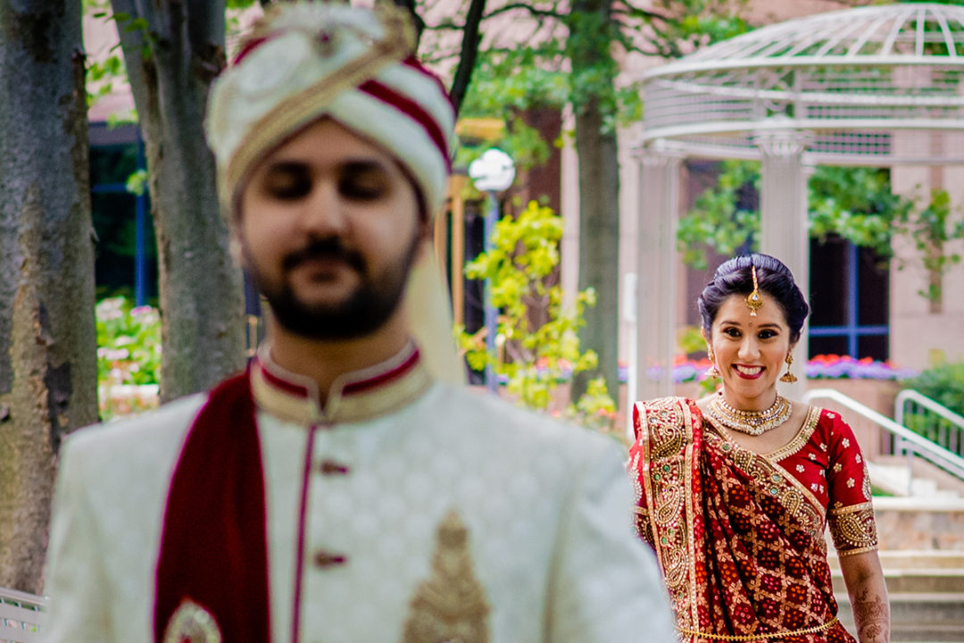 First Look Wedding Pros and Cons. Indian bride and groom's first look at the Dulles Hyatt Virginia by Dc wedding photographers Potok's World Photography