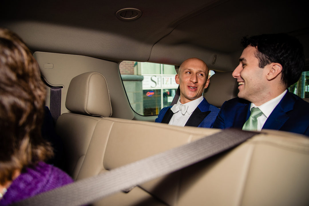 Groom and best man in the car on the way to the church ceremony before the reception at the Carlyle Club Alexandria by northern Virginia wedding photographers of Potok's World Photography