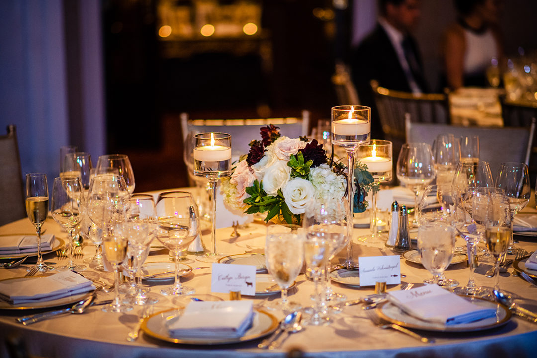 Table decor at a St. Regis DC wedding with candle vases and purple and white bouquets by DC wedding photographers Potok's World Photography