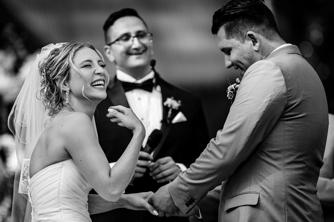 Documentary wedding photography in Washington DC of bride laughing during outdoor ceremony at Tudor Place in Georgetown by Anji Martin of Potok’s World Photography, DC wedding photographer