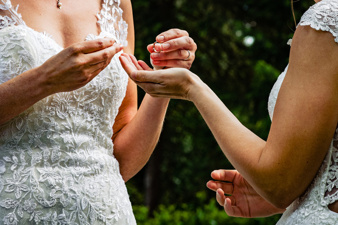 Documentary wedding photography photo of two brides exchanging rings during destination wedding in Germany by Anji Martin of Potok’s World Photography, Washington DC wedding photographer