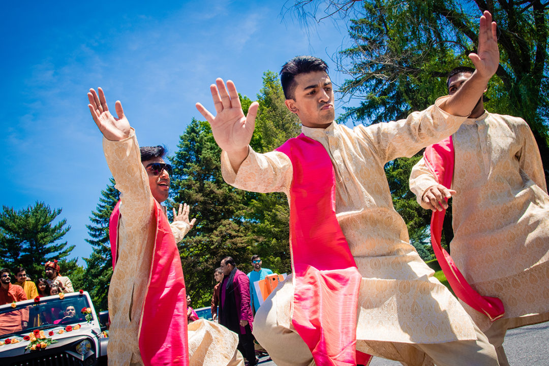 Groom and groomsmen dancing in an Indian Baraat before wedding ceremony by DC wedding photographers Potok's World Photography