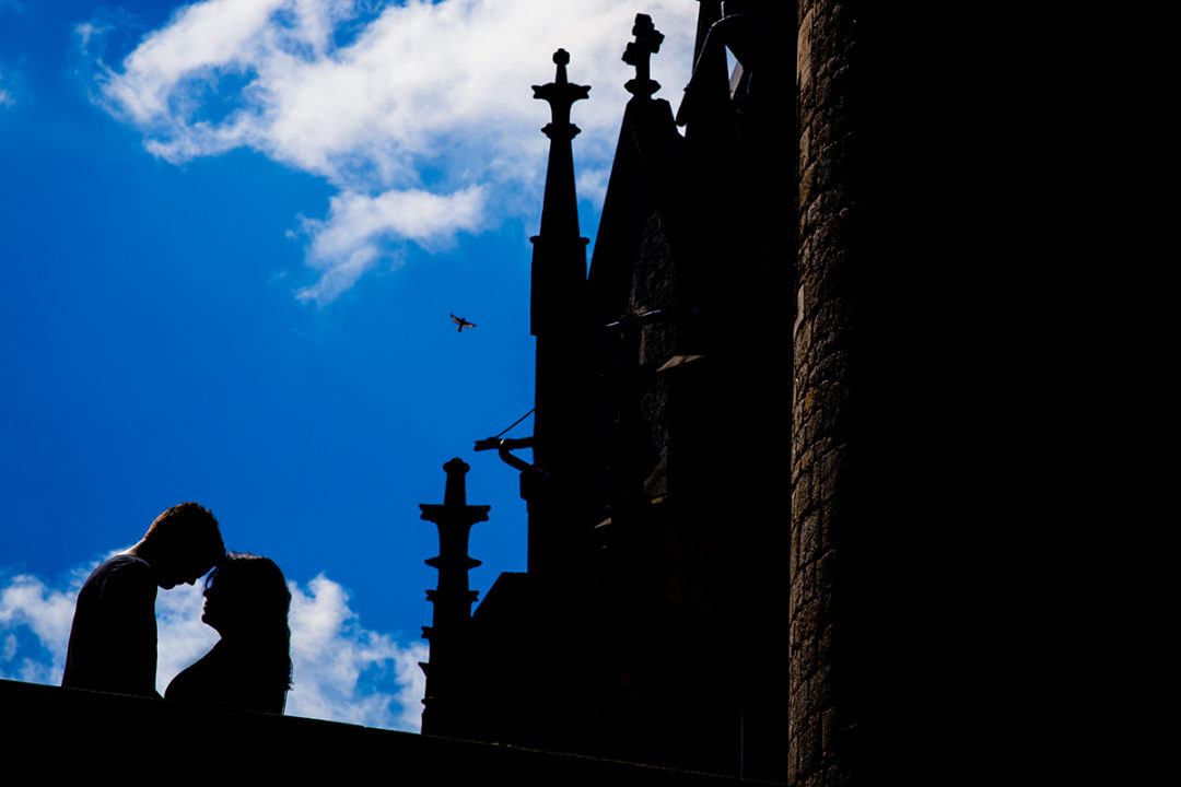 Silhouette of couple against clear blue sky during Marienburg Castle engagement photos in Germany by Washington DC wedding photographers Potok's World Photography