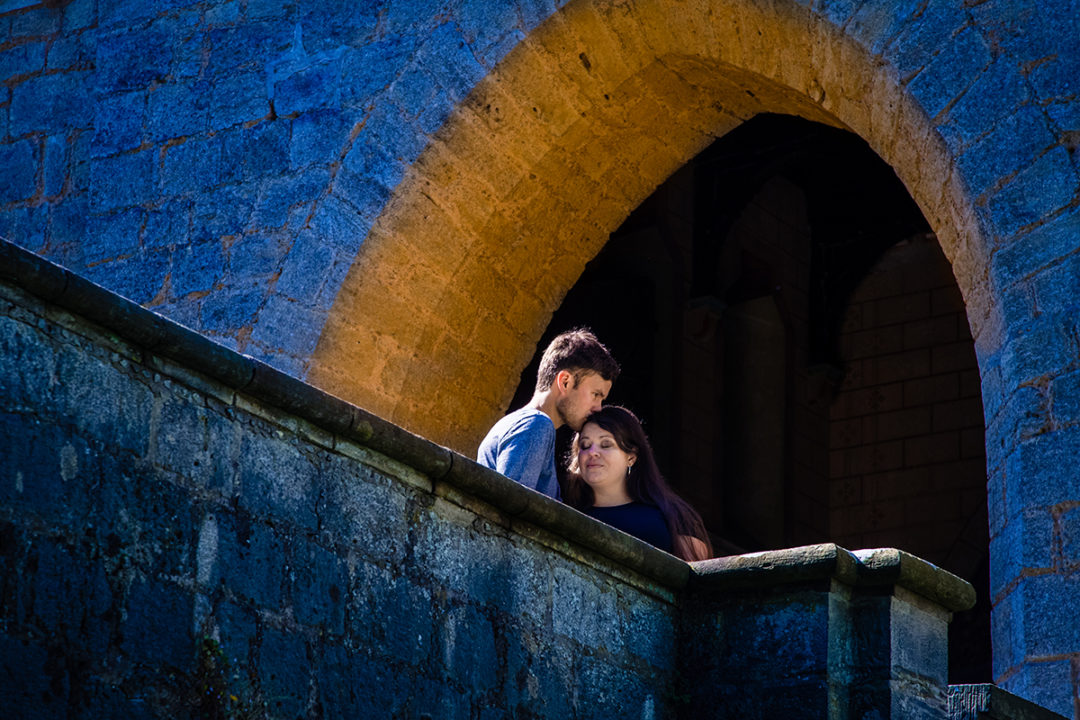 Couple on bridge leading to castle during Marienburg Castle engagement photos in Germany by Washington DC wedding photographers Potok's World Photography