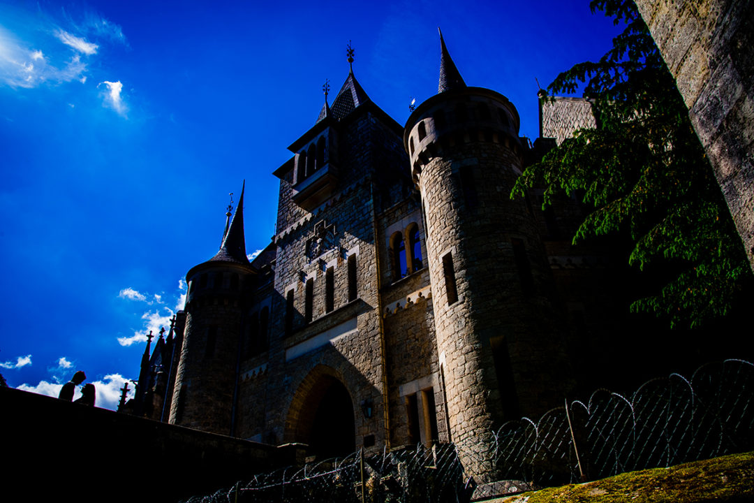 Silhouette of couple against clear blue sky during Marienburg Castle engagement photos in Germany by Washington DC wedding photographers Potok's World Photography