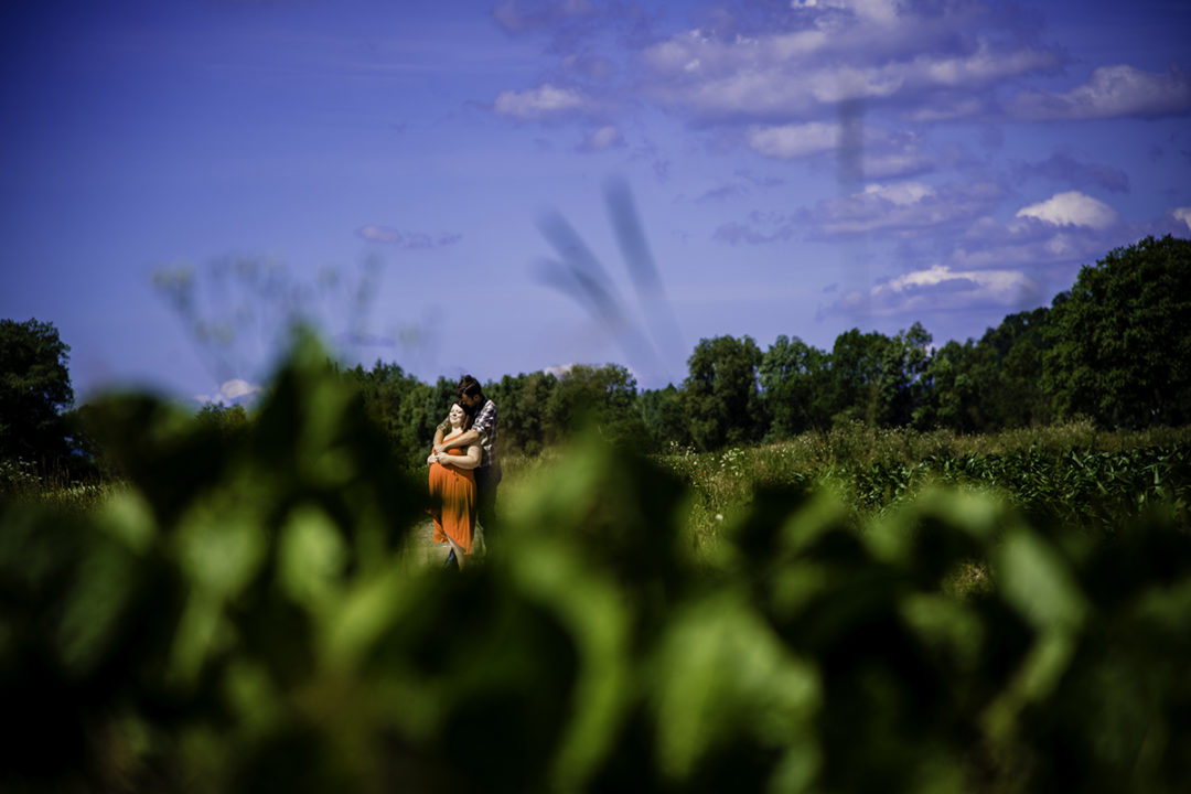 Couple in the fields outside the castle during Marienburg Castle engagement photos in Germany by Washington DC wedding photographers Potok's World Photography