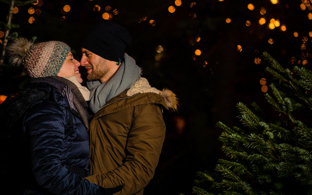 Tips for planning a winter engagement photoshoot at the Christmas market with seasonal lights by DC wedding photographer Potok's World Photography