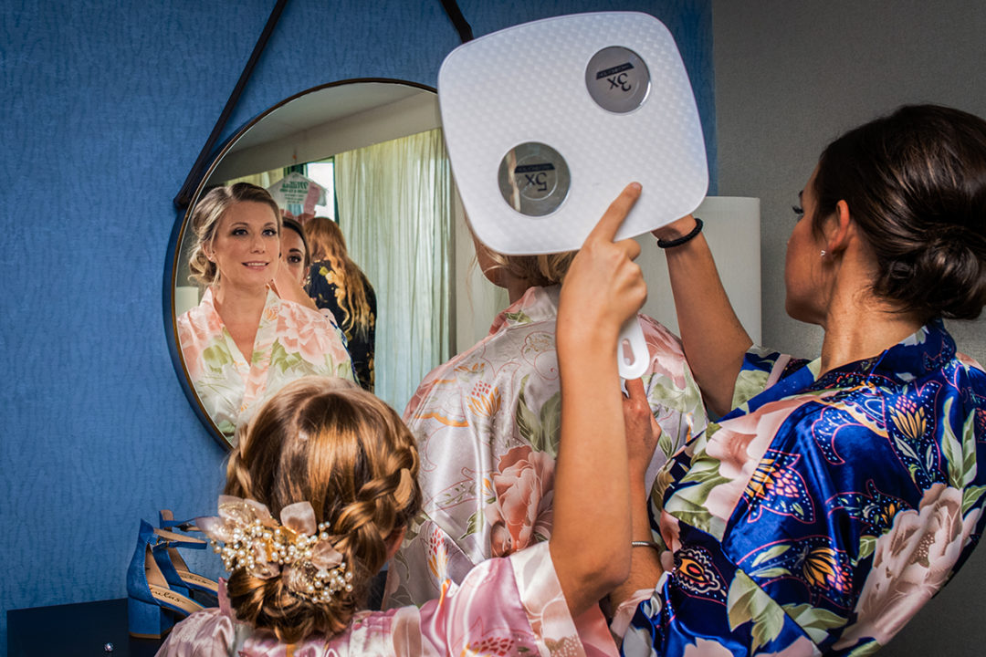 Bride getting ready with her bridesmaids at Lansdowne Resort and Spa in Leesburg before her Vanish Brewery wedding by DC wedding photographers Potok's World Photography