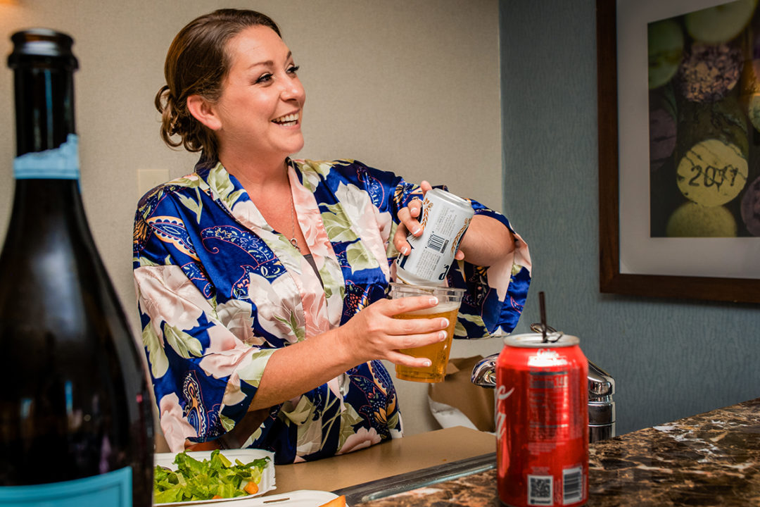 Bride getting ready with her bridesmaids at Lansdowne Resort and Spa in Leesburg before her Vanish Brewery wedding by DC wedding photographers Potok's World Photography