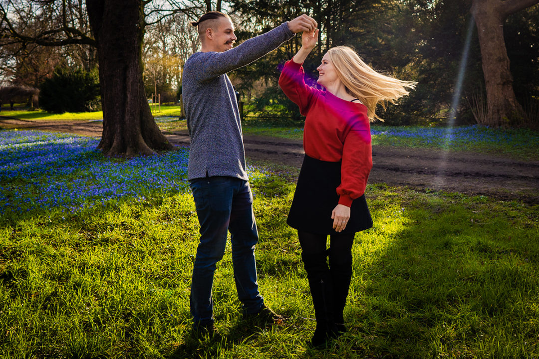 Outdoor spring engagement session of groom spinning his bride-to-be by DC wedding photographers of Potok's World Photography