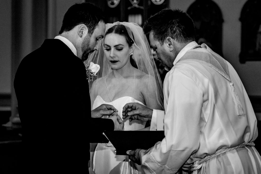 Exchange of rings during Capitol Hill church wedding ceremony by DC wedding photographers of Potok's World Photography