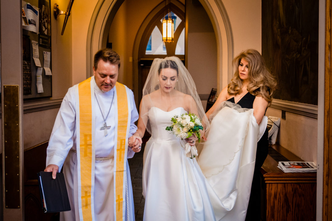 Bride walking down the aisle with her parents during Capitol Hill church wedding by DC photographers of Potok's World Photography