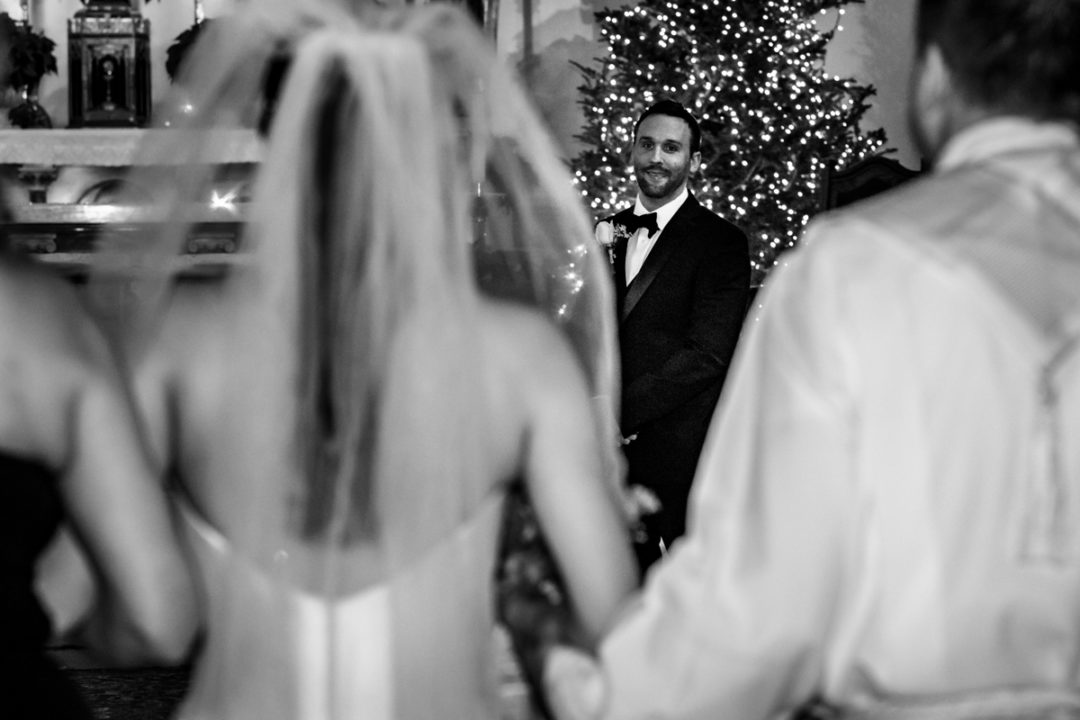 Bride walking down the aisle with her parents during Capitol Hill church wedding by DC photographers of Potok's World Photography