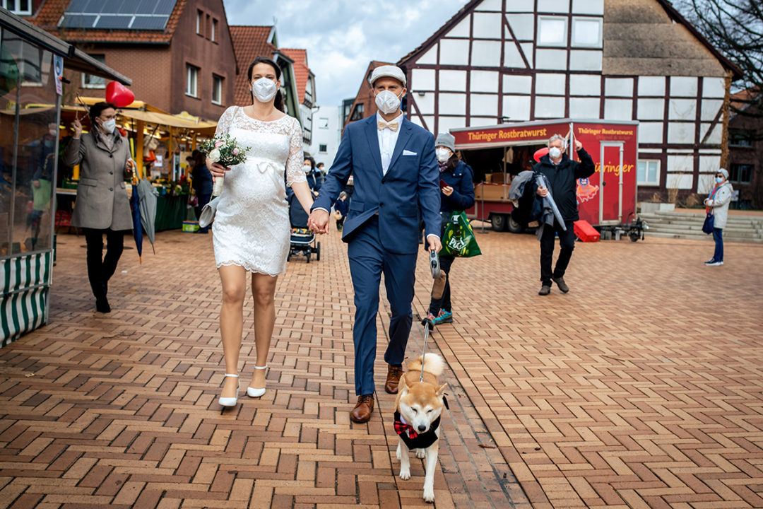 Bride and groom wearing masks and dog in a tux during a Covid-19 courthouse wedding in Gehrden Germany by DC wedding photographers of Potok's World Photography