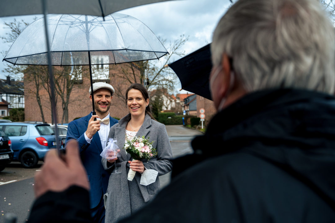 Cocktail hour in the parking lot with people wearing masks during Covid-19 courthouse wedding during Covid-19 in Gehrden Germany by DC wedding photographers of Potok's World Photography