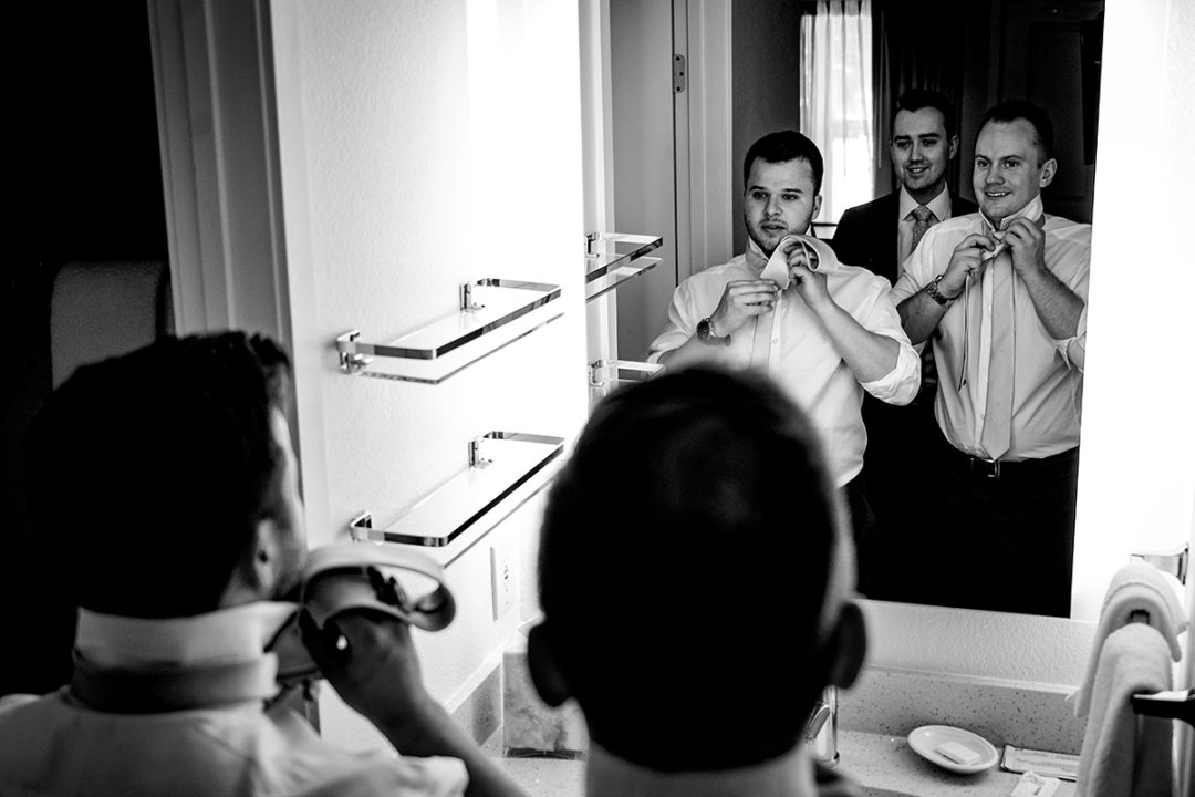 Groom and groomsmen getting ready at hotel before wedding ceremony at the Winery at Bull Run by DC wedding photographers of Potok's World Photography