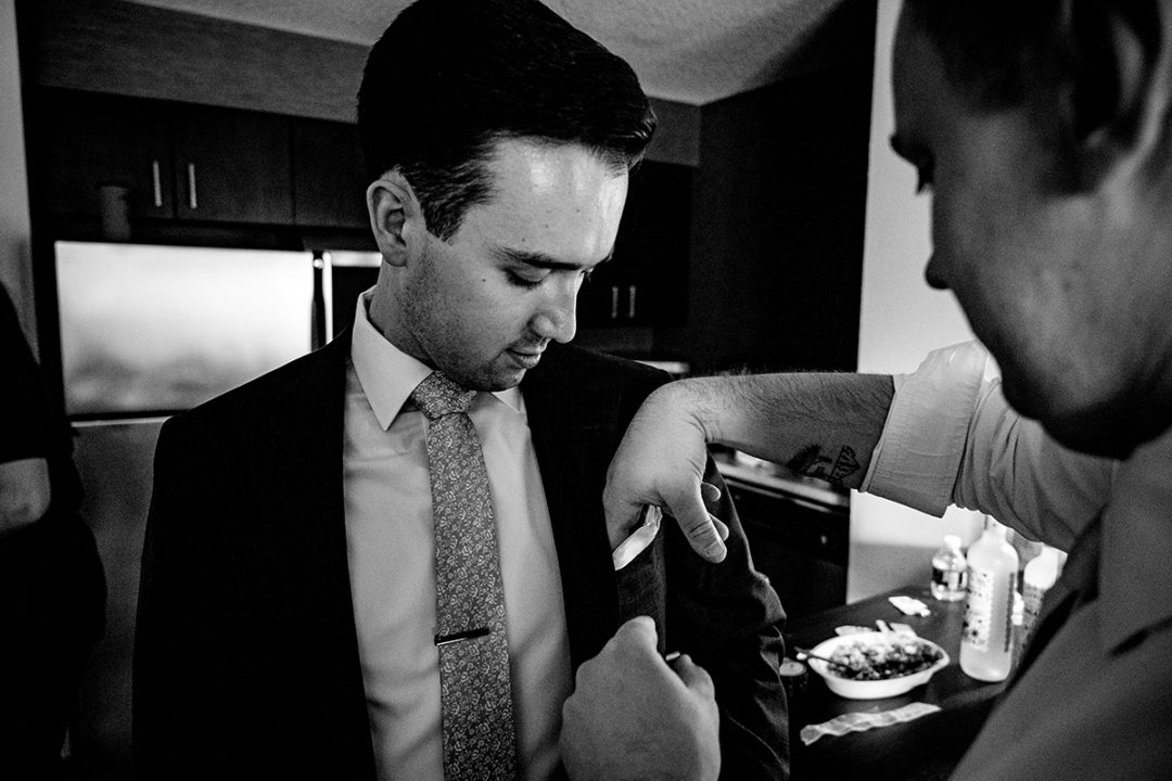 Groom and groomsmen getting ready at hotel before wedding ceremony at the Winery at Bull Run by DC wedding photographers of Potok's World Photography