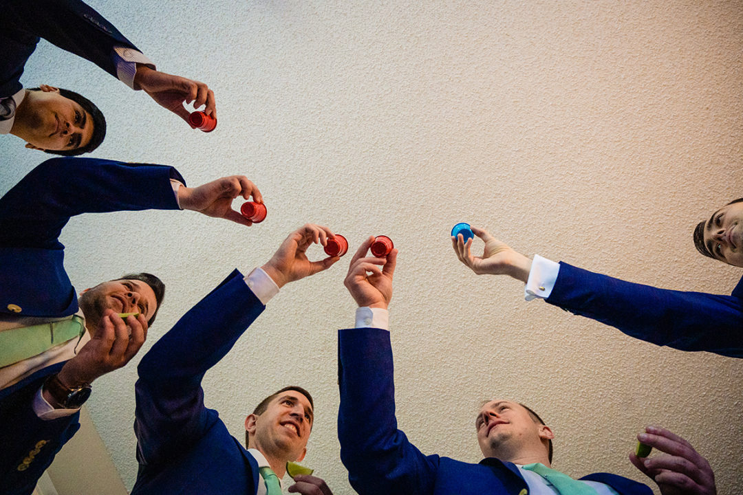 Groom and groomsmen getting ready at hotel before wedding ceremony at the Winery at Bull Run by DC wedding photographers of Potok's World Photography