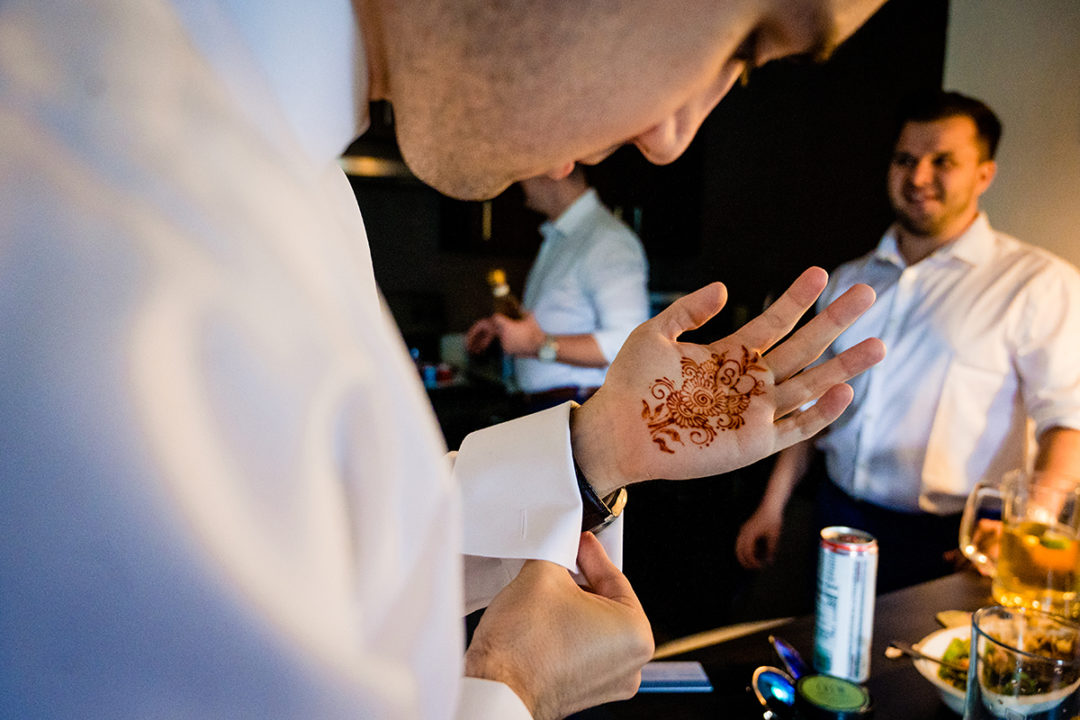 Groom and groomsmen getting ready at hotel before wedding ceremony at the Winery at Bull Run by DC wedding photographers of Potok's World Photography