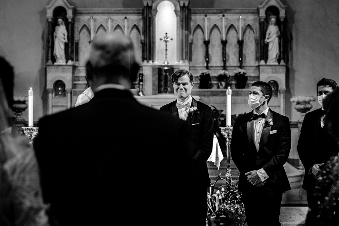 Groom seeing his bride for the first time when she walks down the aisle during their church wedding ceremony in the Nation's Capital by Washington DC wedding photographers of Potok's World Photography