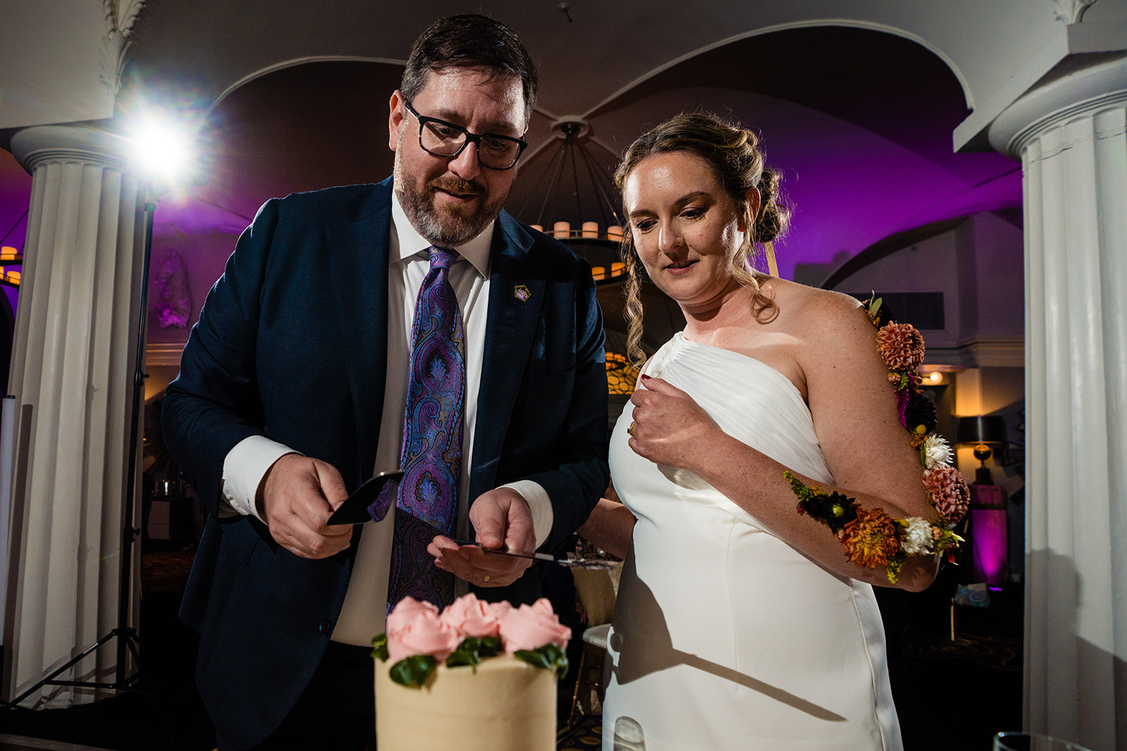 Cake cutting by the bride and groom at the wedding reception at Hotel Monaco in Washington DC by Potok's World Photography